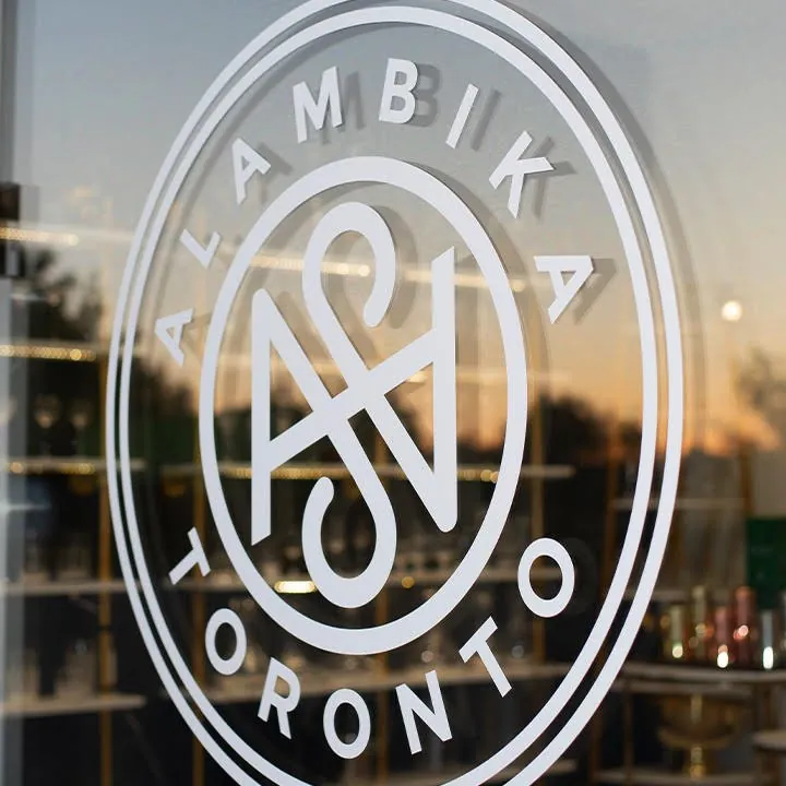 Alambika Toronto — window monogram
