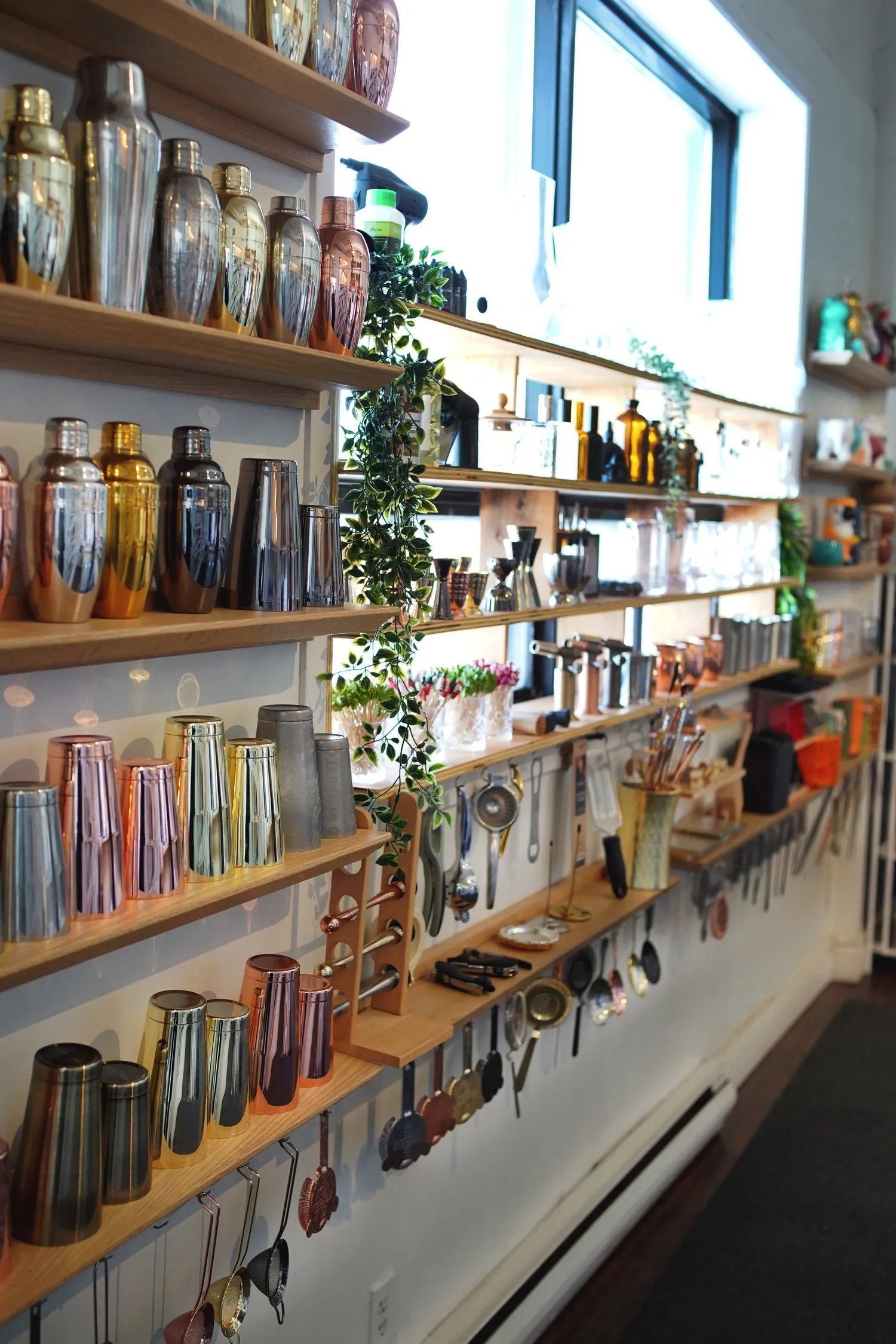 The barware wall — shakers, jiggers, strainers